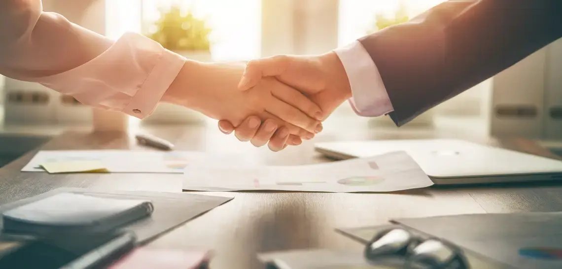 agent and business owner shaking hands