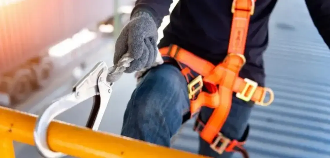 construction worker tied into scaffolding