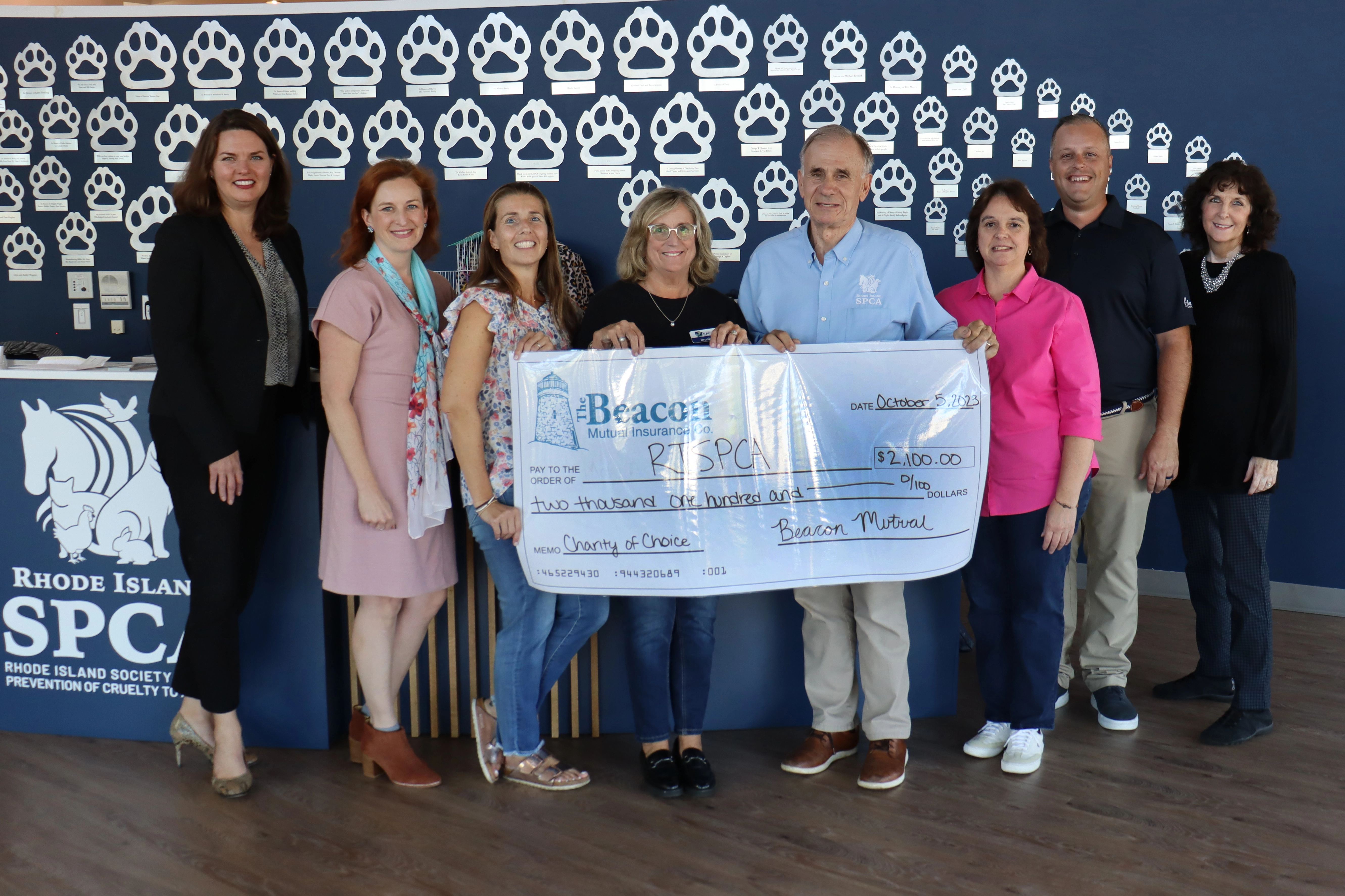 Beacon employees awarding a check to the RISPCA