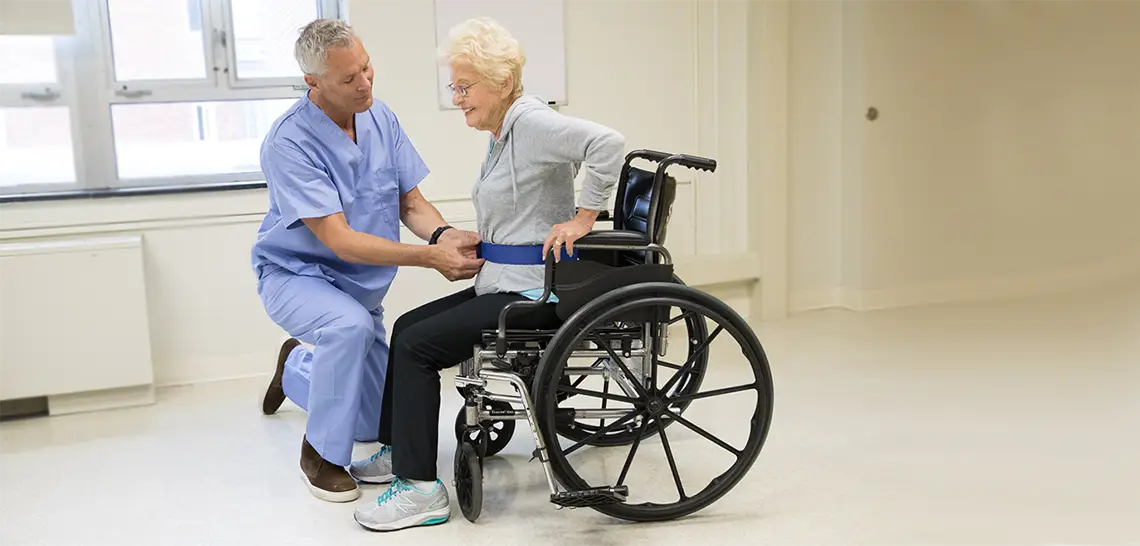 Caregiver assisting a wheelchair patient