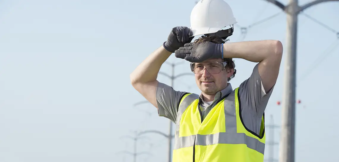Worker wiping forehead in heat